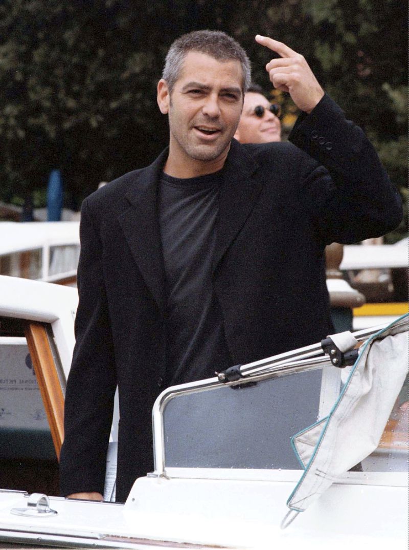 FILE - George Clooney arrives at the Lido for the Venice Film Festival in Venice, Italy, on Sept. 8, 1998, to promote the Steven Soderbergh film "Out Of Sight." (AP Photo/Francesco Proietti, File)