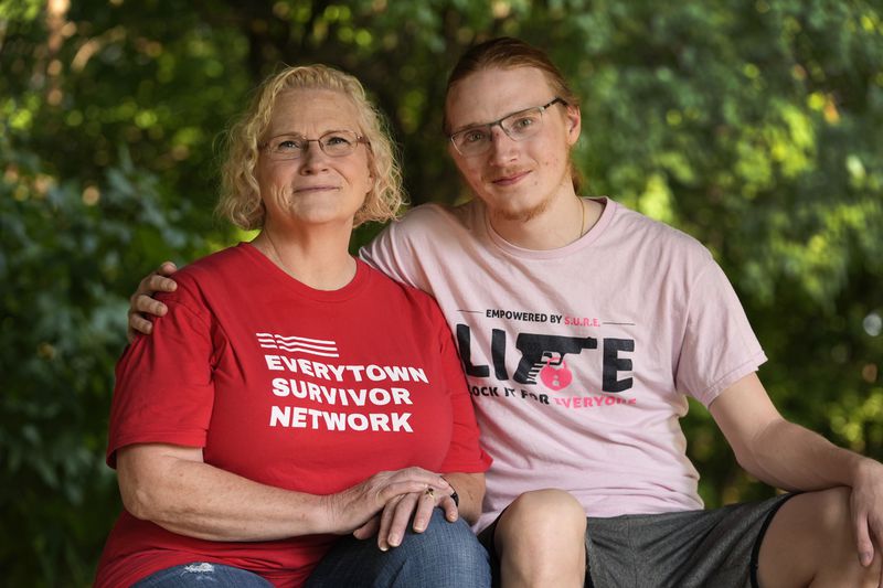 Denise Wieck and her son Guy Boyd, who was shot in the eye with a ghost gun, pose in Ypsilanti, Mich., Saturday, Sept. 14, 2024. (AP Photo/Paul Sancya)