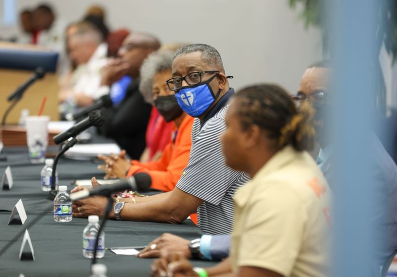 Pastor Keith Reynolds listens as a woman talks about losing her son to gun violence during a meeting on gun violence and school safety in Clayton County Schools at North Clayton Middle School on Tuesday, May 3, 2022, in College Park, Ga. Branden Camp/For the Atlanta Journal-Constitution