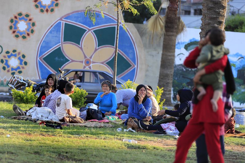 Lebanese citizens who fled the southern villages amid ongoing Israeli airstrikes Monday, sit at a park in the southern port city of Sidon, Lebanon, Tuesday, Sept. 24, 2024. (AP Photo/Mohammed Zaatari)