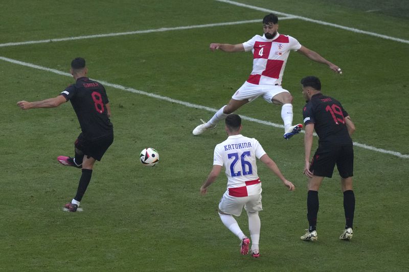 Albania's Klaus Gjasula, left, scores his side's second goal during a Group B match between Croatia and Albania at the Euro 2024 soccer tournament in Hamburg, Germany, Wednesday, June 19, 2024. (AP Photo/Sunday Alamba)