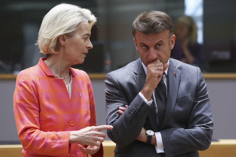 FILE - French President Emmanuel Macron, right, speaks with European Commission President Ursula von der Leyen during a round table meeting at an EU summit in Brussels, Thursday, June 27, 2024. Emmanuel Macron once appeared as a bold, young leader offering to revive France through radical pro-business, pro-European policies so that voters have "no reason anymore" to vote for the extremes. Seven years after he was first elected, his call for snap elections weakens him at home and abroad, while it appears to propel the far right on the verge of power. (Olivier Hoslet, Pool Photo via AP, File)