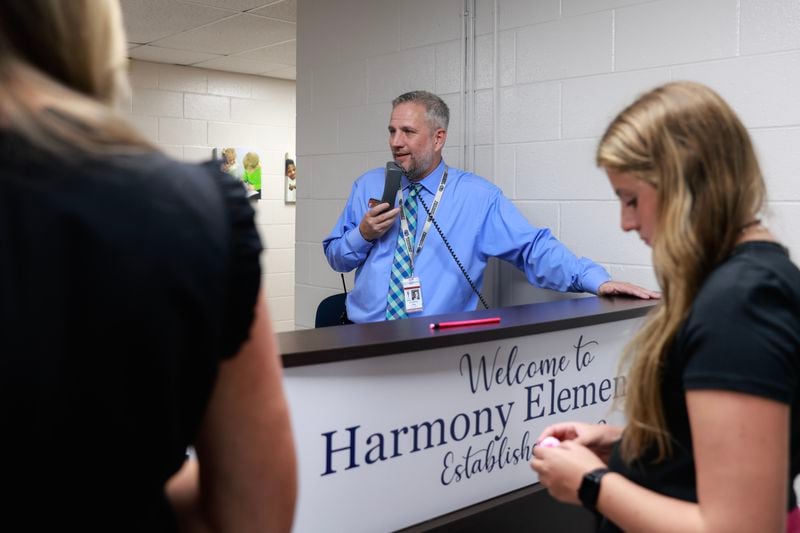 Harmony Elementary School Principal Jonathan Day makes an announcement on the PA system on the first day of school on Wednesday, Aug. 2, 2023. (Natrice Miller/ Natrice.miller@ajc.com) 