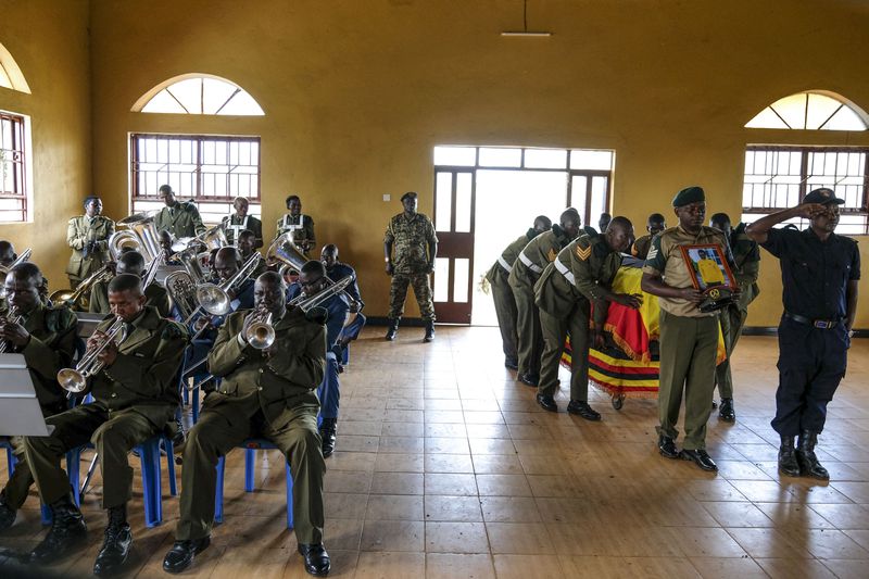 Members of Uganda People's Defence Force (UPDF) carry the coffin of their colleague Ugandan Olympic athlete Rebecca Koriny Cheptegei, ahead of her burial in Kapkoros, Bukwo District, Uganda Saturday, Sept. 14. 2024. (AP Photo/Hajarah Nalwadda)