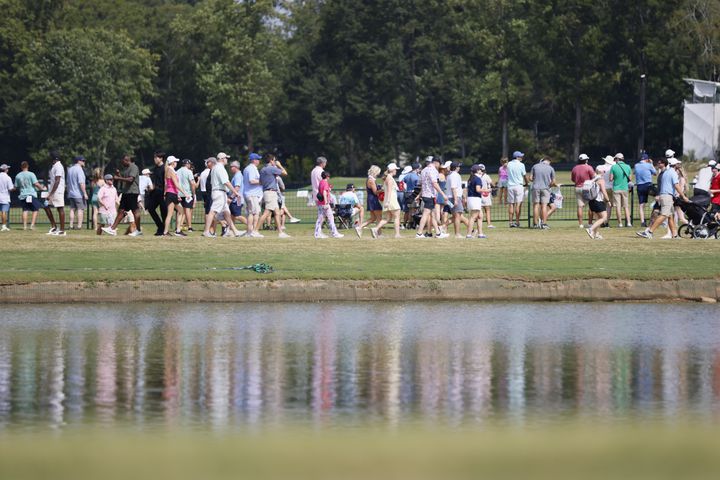 Fans walk near the driving range during the fourth round of the Tour Championship at East Lake Golf Club on Sunday, Sept. 1, 2024, in Atlanta. 
(Miguel Martinez / AJC)