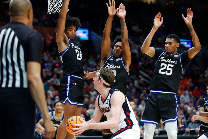 Gonzaga forward Drew Timme, lower center, holds the ball as Georgia State's Collin Moore (24), Kane Williams, upper center, and Jalen Thomas (25) leap to defend during the second half of a first round NCAA college basketball tournament game, Thursday, March 17, 2022, in Portland, Ore. (AP Photo/Craig Mitchelldyer)