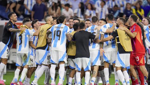 Players of Argentina celebrate defeating Ecuador in a penalty shootout in a Copa America quarterfinal soccer match in Houston, Thursday, July 4, 2024. (AP Photo/Julio Cortez)