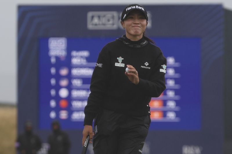 Lydia Ko, of New Zealand, acknowledges the crowd after putting and making par on the 17th green during the final round of the Women's British Open golf championship, in St. Andrews, Scotland, Sunday, Aug. 25, 2024. (AP Photo/Scott Heppell)