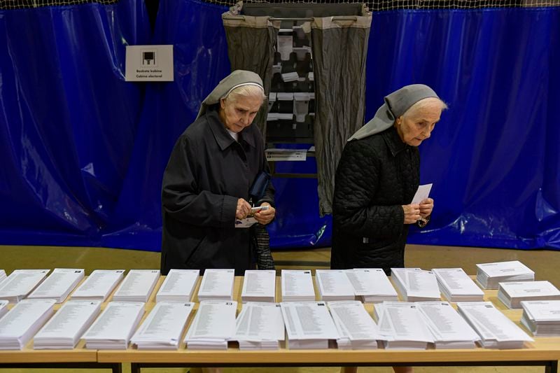 Nuns look at ballot papers at a polling station in Pamplona, northern Spain, on Sunday, June 9, 2024. Pivotal elections for the European Union parliament reach their climax Sunday as the last 27 nations go to the polls and results are announced in a vote that boils down to a continent-wide battle between eurosceptic populists and proponents of closer EU unity. (AP Photo/Alvaro Barrientos)
