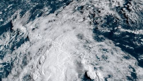 This Aug. 25, 2024 satellite image provided by the National Oceanic and Atmospheric Administration shows Hurricane Hone passing south of Hawaii. (NOAA via AP)