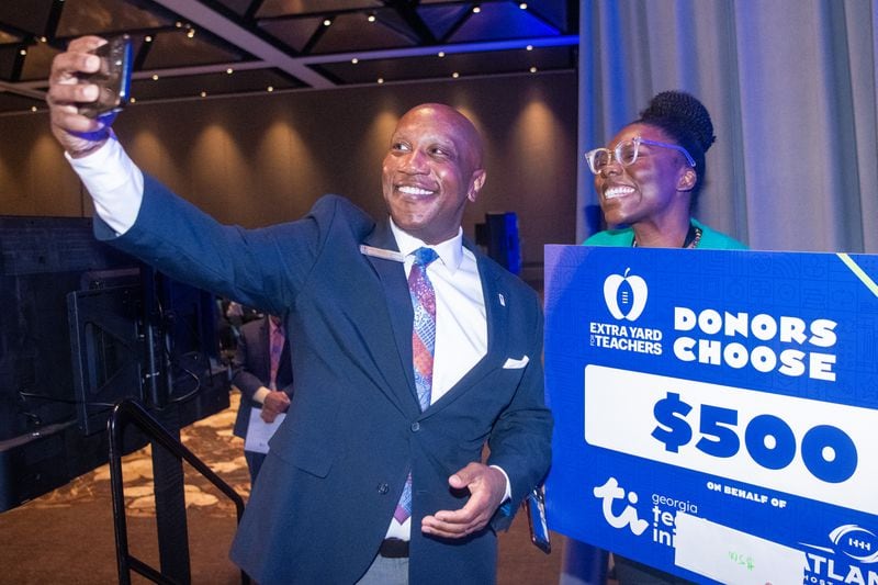 Gwinnett County Public Schools Superintendent Calvin Watts, (left), takes a selfie with Tyrae Jones, a first grade teacher in Partee Elementary School at the district's new teacher orientation in Duluth on Thursday, July 18, 2024. (Ziyu Julian Zhu/AJC)