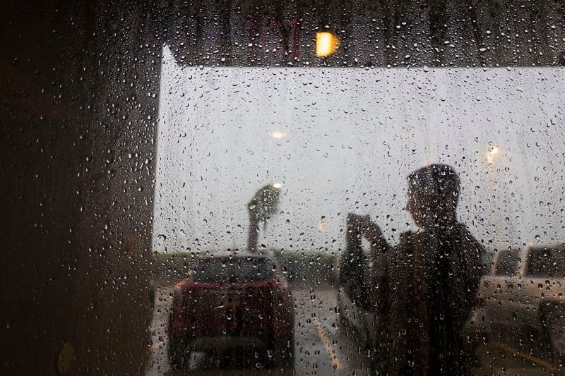 Hotels guests at the Fairfield by Marriott Inn & Suites stand in a protected entryway as they take video of the powerful forces coming from the Hurricane Francine eye wall as it moves across the south on Wednesday, Sept. 11, 2024, in Houma, La. (Photo by Chris Granger, The Times-Picayune)/The Times-Picayune/The New Orleans Advocate via AP)/The Times-Picayune/The New Orleans Advocate via AP)