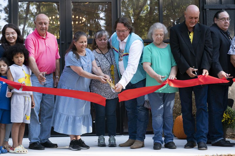 Members of the Shawnee Tribe cut the ribbon at the Shawnee Language Center on Friday, September 20, 2024 in Miami, Okla.. (AP Photo/Nick Oxford)