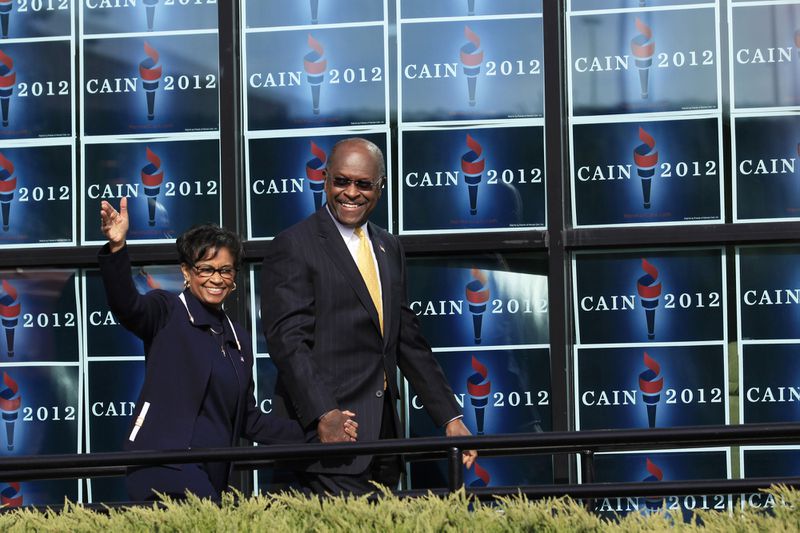 Herman Cain, as a Republican presidential candidate, approaches the stage with his wife, Gloria, to speak at a campaign event in Atlanta on Dec. 3, 2011. Cain, a former business executive who was recently hospitalized with the coronavirus, has died, current and former employees confirmed Thursday. He was 74. (Philip Scott Andrews/The New York Times)