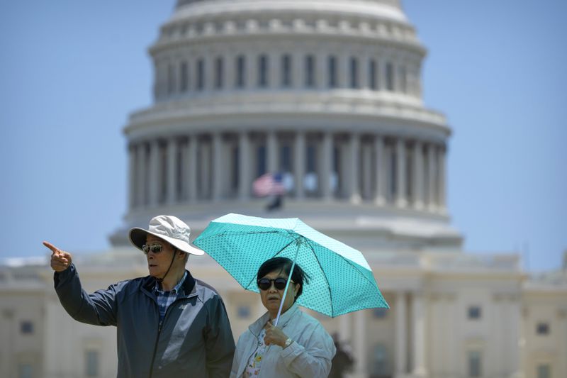 Recent visitors near the Capitol in Washington wore coats, hats and sunglasses to protect themselves from the sun. The U.S. House is in session today.