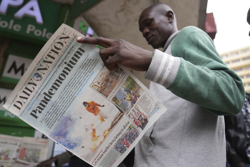 A man reads about yesterday's protest in a newspaper in downtown Nairobi, Kenya Wednesday, June 26, 2024. Thousands of protesters stormed and burned a section of Kenya's parliament Tuesday to protest tax proposals. Police responded with gunfire and several protesters were killed. (AP Photo/Brian Inganga)
