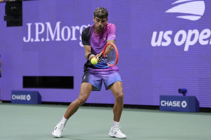 Flavio Cobolli, of Italy, returns a shot to Daniil Medvedev, of Russia, during the third round of the U.S. Open tennis championships, Saturday, Aug. 31, in New York. 2024. (AP Photo/Matt Rourke)