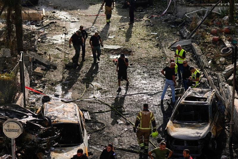 Israeli security forces examine the site hit by a rocket fired from Lebanon, in Kiryat Bialik, northern Israel, on Sunday, Sept. 22, 2024. (AP Photo//Ariel Schalit)