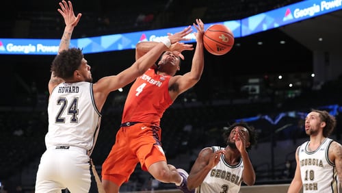012021 Atlanta: Georgia Tech center Rodney Howard forces a loose ball defending against Clemson guard Nick Honor in an NCAA college basketball game on Tuesday, Jan. 20, 2021, in Atlanta. Georgia Tech upset Clemson 83-65.      Curtis Compton / Curtis.Compton@ajc.com���