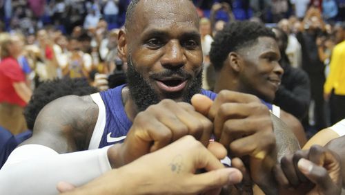 United States' forward LeBron James bumps fists with teammates after the end of an exhibition basketball game between the United States and South Sudan, at the o2 Arena in London, Saturday, July 20, 2024. (AP Photo/Kin Cheung)