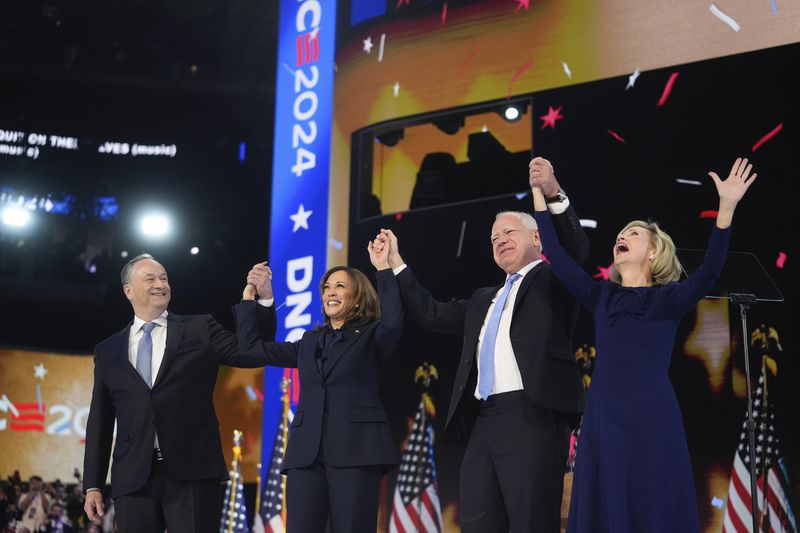 Democratic presidential nominee Vice President Kamala Harris with Second gentleman Douglas Emhoff and Democratic vice presidential candidate Minnesota Gov. Tim Walz with his wife Gwen Walz celebrate during the Democratic National Convention Thursday, Aug. 22, 2024, in Chicago. (AP Photo/Erin Hooley)