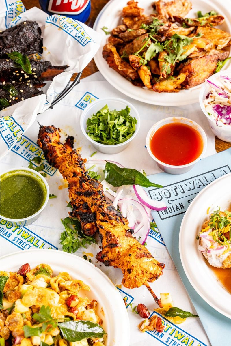 Botiwalla Chicken Tikka. In this photo, the skewer is served with mint and cilantro chutney (left) plus chopped cilantro and tamarind chutney. (Courtesy of Tim Robison)