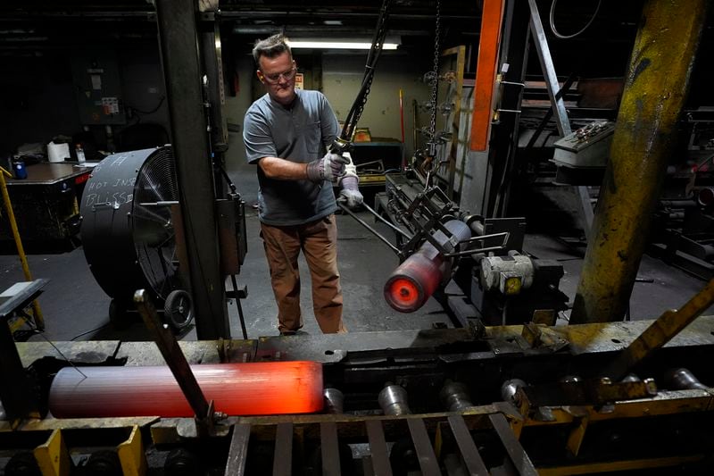 A steel worker moves heated 155 mm M795 artillery projectiles during the manufacturing process at the Scranton Army Ammunition Plant, Tuesday, Aug. 27, 2024, in Scranton, Pa. (AP Photo/Matt Slocum)