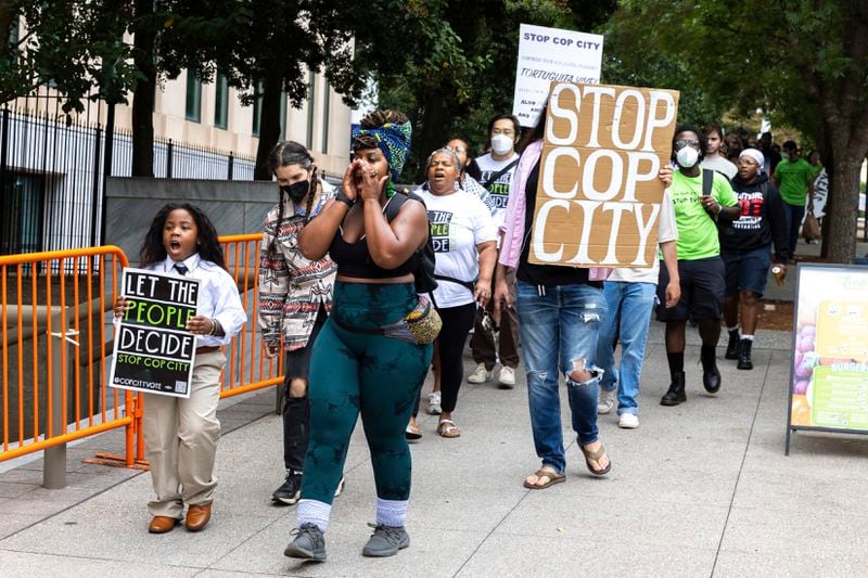 Opponents of an under-construction law enforcement training center, known to some as "Cop City," protest at City Hall in Atlanta on Monday, Sept. 16, 2024. It's been one year since opponents submitted a petition to force a referendum to block the project. (Arvin Temkar/Atlanta Journal-Constitution via AP)