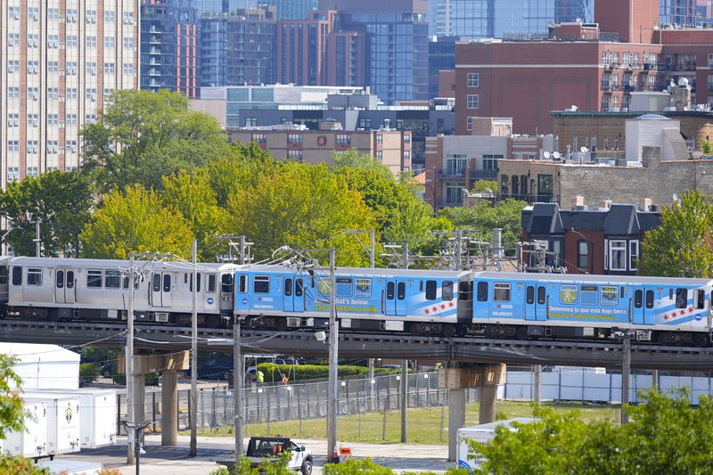 A Chicago Transit Authority (CTA) Pink Line train goes by near the United Center on Tuesday, Aug. 13, 2024. The Democratic National Convention is scheduled to start the following Monday. (AP Photo/Pablo Martinez Monsivais)