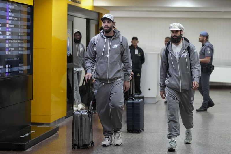 The Philadelphia Eagles' Dallas Goedert, left, and teammates arrive at Sao Paulo International airport in Guarulhos, greater Sao Paulo, Brazil, Wednesday, Sept. 4, 2024. (AP Photo/Andre Penner)