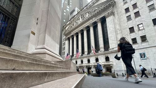 Pedestrians pass the New York Stock Exchange, on Tuesday, Aug. 20, 2024, in New York. (AP Photo/Peter Morgan)