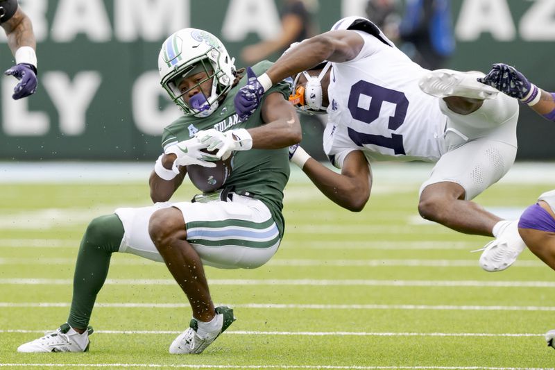 Tulane wide receiver Yulkeith Brown (5) makes a reception as Kansas State safety VJ Payne (19) makes the tackle during the first half of an NCAA college football game in New Orleans, Saturday, Sept. 7, 2024. (AP Photo/Matthew Hinton)