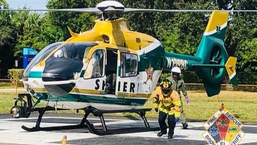 Paramedics prepare to take a construction worker who severed his right arm in an accident to the hospital.