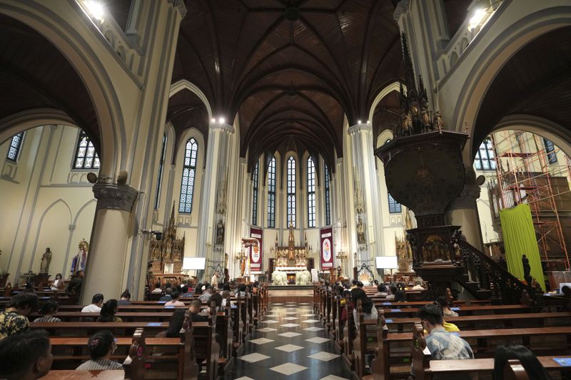 People attend an evening mass at The Church of Our Lady of the Assumption, popularly known as the Jakarta Cathedral, in Jakarta, Indonesia, Thursday, Aug. 8, 2024. (AP Photo/Achmad Ibrahim)