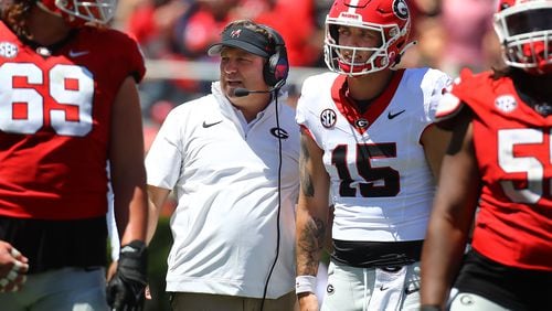 Coach Kirby Smart confers with Carson Beck between plays during the G-Day game Saturday, April 13, 2024.  Curtis Compton for The Atlanta Journal-Constitution
