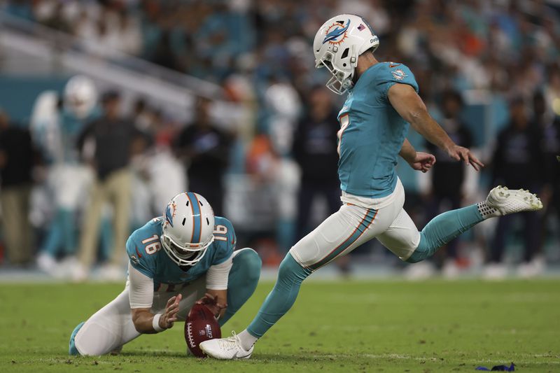 Miami Dolphins place kicker Jason Sanders (7) kicks a field goal as punter Jake Bailey (16) holds the ball during the first half of an NFL football game against the Tennessee Titans, Monday, Sept. 30, 2024, in Miami Gardens, Fla. (AP Photo/Brennan Asplen)