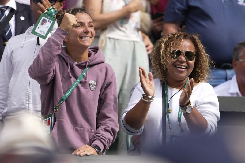 Sara Erani, left, and Jacqueline Paolini, mother of Jasmine react following her semifinal win over Donna Vekic of Croatia at the Wimbledon tennis championships in London, Thursday, July 11, 2024. (AP Photo/Alberto Pezzali)
