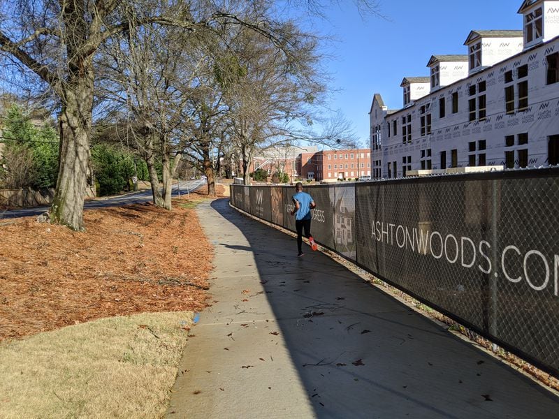 Brookhaven is building its path network one property at a time by requiring developers to either build segments in front of their projects or pay into a fund, depending on whether they are building along a planned route. A jogger is on this new stretch on North Druid Hills Road on Dec. 24, 2019, near Briarwood Road. It’s on the route the city will use to connect the Peachtree Creek Greenway at Briarwood to a MARTA station on Peachtree Road. TY TAGAMI / TY.TAGAMI@AJC.COM