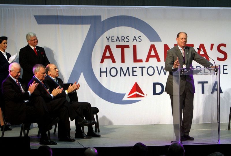 110121-ATLANTA: (left to right, seated) US Sen Saxby Chambliss, Gov. Nathan Deal &amp; Coke CEO Muhtar Kent applaud Delta CEO Richard Anderson's speech during a 70th anniversary event at the airlines Technical Operations Center at Hartsfield-Jackson Atlanta International Airport on Friday, January 21st. Anderson also recognized Lynda Lloyd as being the longest-serving employee in Atlanta. The event culminated with the christening of a Delta Boeing 777 as the "Spirit of Atlanta." Phil Skinner pskinner@ajc.com editor's note: CQ