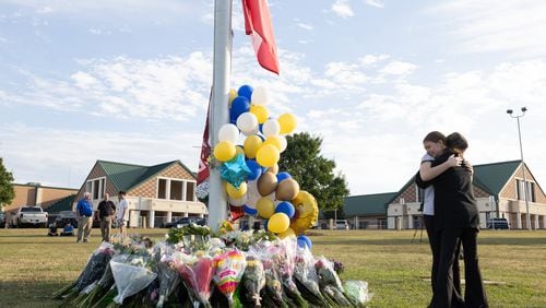 Students embrace near a makeshift memorial at Apalachee High School on Sept. 5, 2024, in Winder, Georgia.  (Jessica McGowan/Getty Images/TNS)