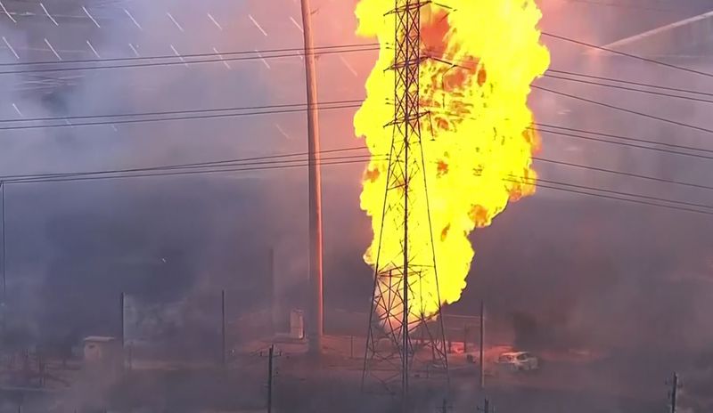 A burned vehicle sits near a pipeline fire in La Porte, Texas, Monday, Sept. 16, 2024. (KTRK via AP)