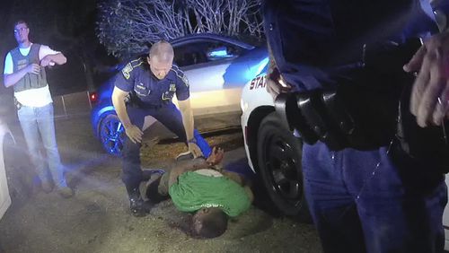 FILE — This image from video from Louisiana state trooper Lt. John Clary's body-worn camera shows trooper Kory York standing over Ronald Greene on his stomach on May 10, 2019, outside of Monroe, La. (Lt. John Clary/Louisiana State Police via AP, File)