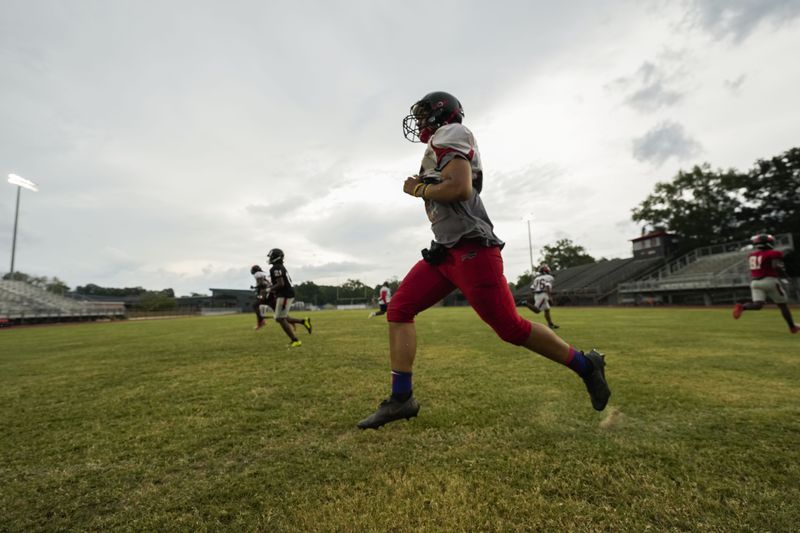 Members of the Baker High football team warm up at practice in Baker, La., Wednesday, Aug. 28, 2024. (AP Photo/Gerald Herbert)