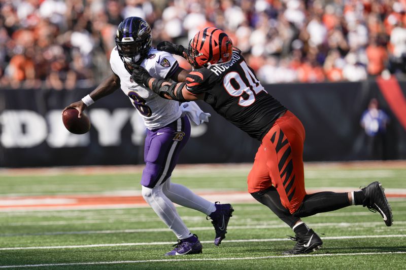 Baltimore Ravens quarterback Lamar Jackson (8) scrambles as Cincinnati Bengals defensive end Sam Hubbard (94) applies pressure during the second half of an NFL football game, Sunday, Oct. 6, 2024, in Cincinnati. (AP Photo/Jeff Dean)