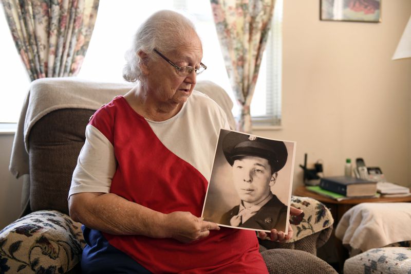 Donna Kennedy holds a photo of her cousin, Cpl. Charles Ray Patten who was buried with full military honors, Monday, May 20, 2024 in Lawson, Mo. He was identified by the Defense POW/MIA Accounting Agency. Patten died 74 years earlier in the Korean War, but spent decades buried as an unknown in the National Memorial Cemetery of the Pacific in Hawaii. (AP Photo/Nick Ingram)