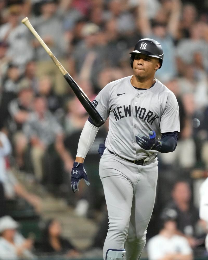 New York Yankees' Juan Soto tosses his bat after hitting a home run off Chicago White Sox relief pitcher Fraser Ellard, Soto's third of the game, during the seventh inning of a baseball game Tuesday, Aug. 13, 2024, in Chicago. (AP Photo/Charles Rex Arbogast)