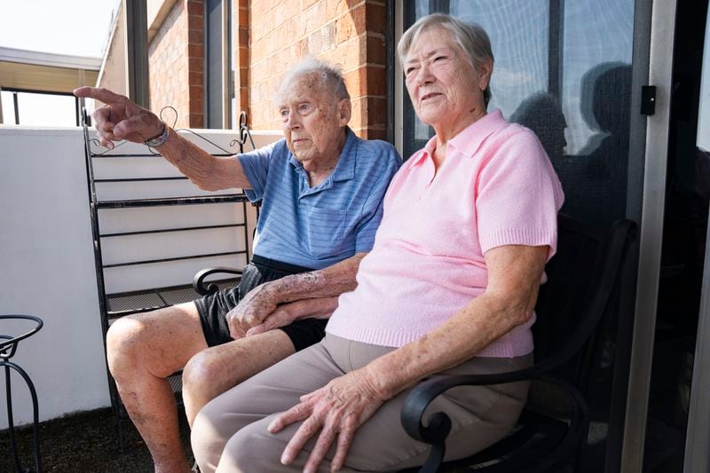 Frank Stovallsits next to his companion and next door neighbor, Agnes Benson, on the balcony of his condo in Sandy Springs. This act represents a daily ritual: they enjoy watching sunrises together. (Olivia Bowdoin for the AJC)