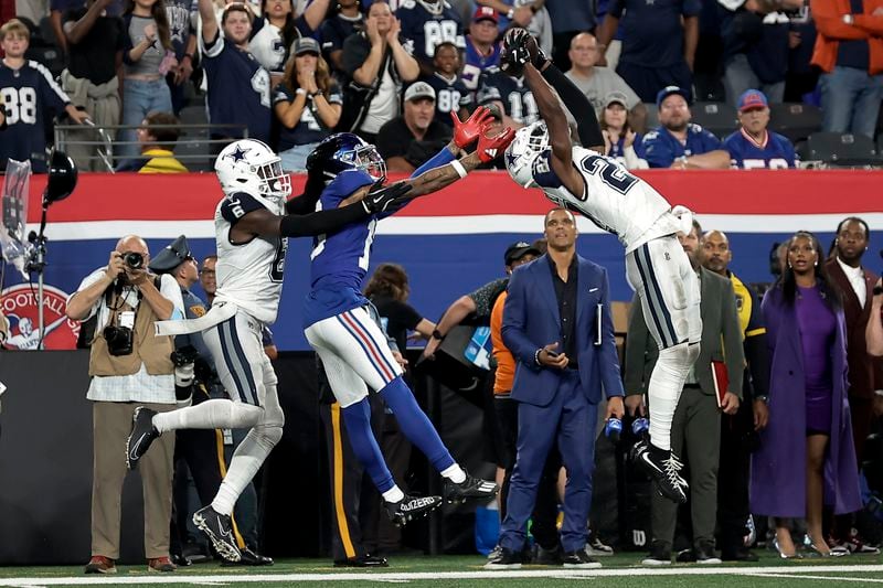 Dallas Cowboys cornerback Amani Oruwariye (27) intercepts a pass intended for New York Giants wide receiver Isaiah Hodgins (18) during the fourth quarter of an NFL football game, Thursday, Sept. 26, 2024, in East Rutherford, N.J. (AP Photo/Adam Hunger)