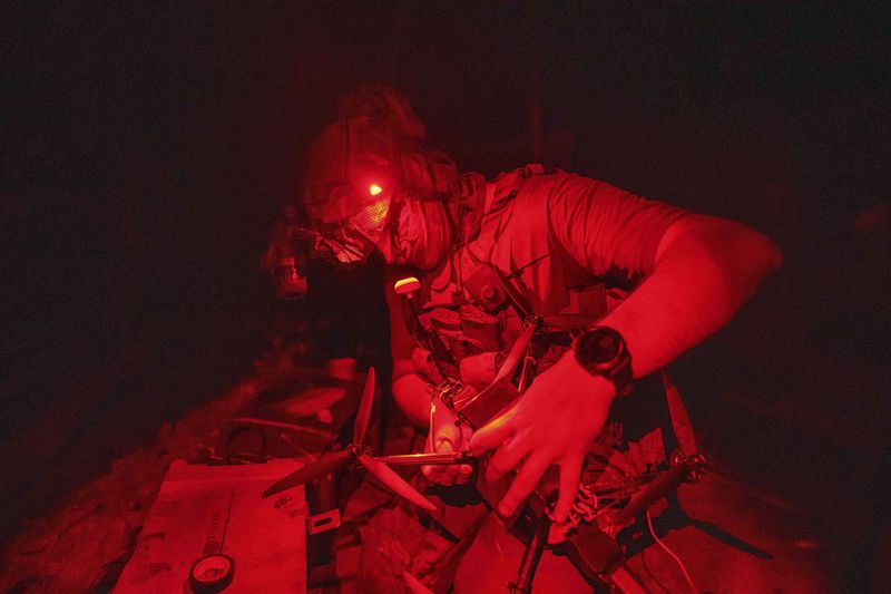 A Ukrainian soldier of 3rd assault brigade prepares FPV suicide drone before flight over Russian positions in Kharkiv region, Ukraine, on Sunday, Aug. 25, 2024. (AP Photo/Evgeniy Maloletka)