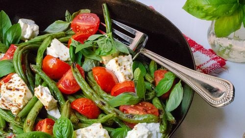 Roasted green beans with feta cheese, tomatoes, red pepper flakes, fresh basil and quality olive oil is a flavor explosion. 
(Virginia Willis for The Atlanta Journal-Constitution)